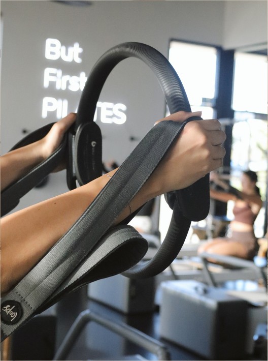Pilates ring workout by the studio window