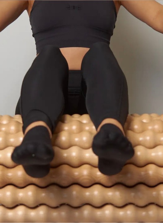 Legs resting on a recovery roller mat